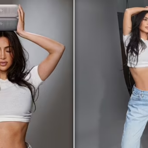 Kim Kardashian bares her abs in a tiny white crop and jeans while promoting her collaboration with Beats by Dre Kim Kardashian bares her abs in a tiny white crop and jeans while promoting her collaboration with Beats by Dre
