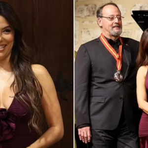 Eva Longoria cuts a stylish figure in a plunging maroon dress as she attends charity wine auction in France